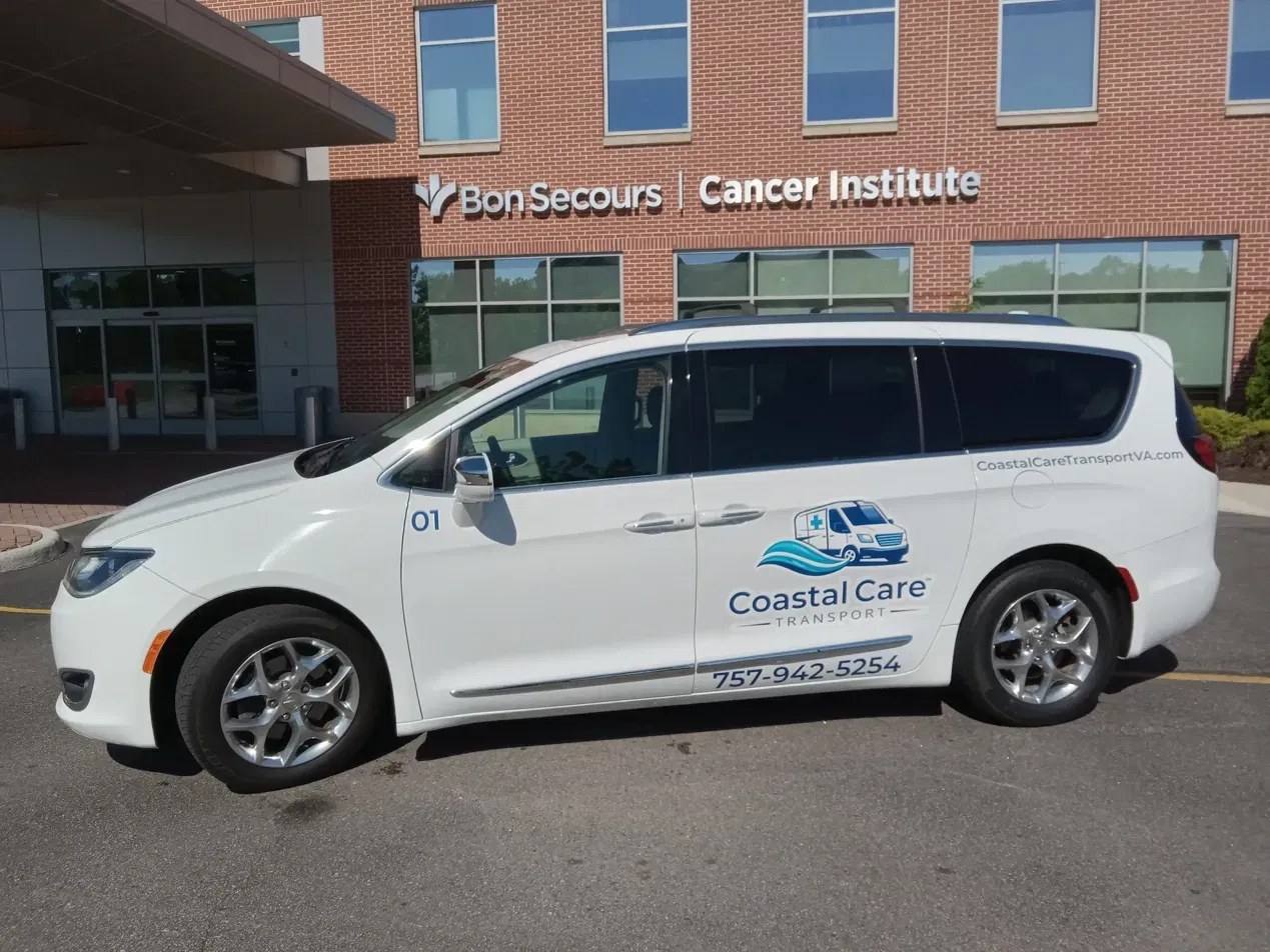 Coastal Care Transport vehicle parked at a medical center for non-emergency medical transportation